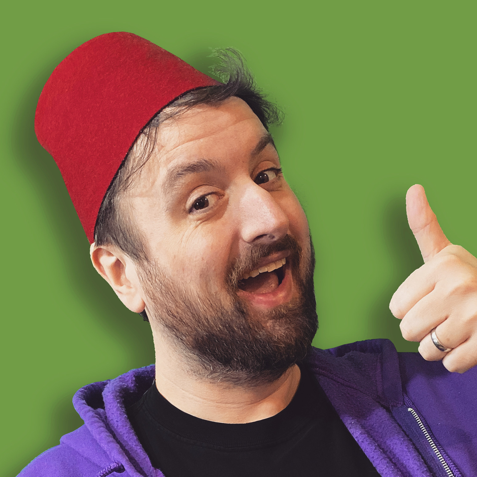 DrGluon smiling, wearing his trademark red fez, and giving a "thumbs up"